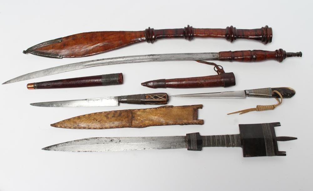 FOUR AFRICAN EDGED WEAPONS comprising two Bou Saa'da daggers with highly decorative wire wound grips Image