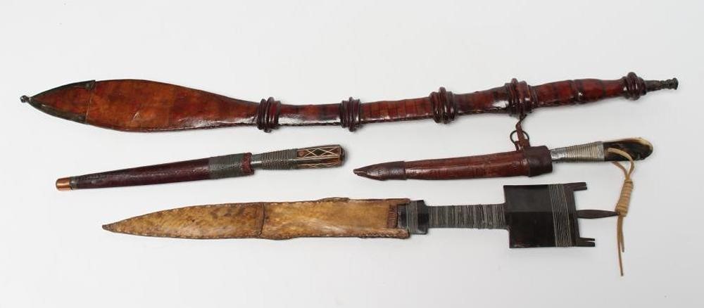 FOUR AFRICAN EDGED WEAPONS comprising two Bou Saa'da daggers with highly decorative wire wound grips Image