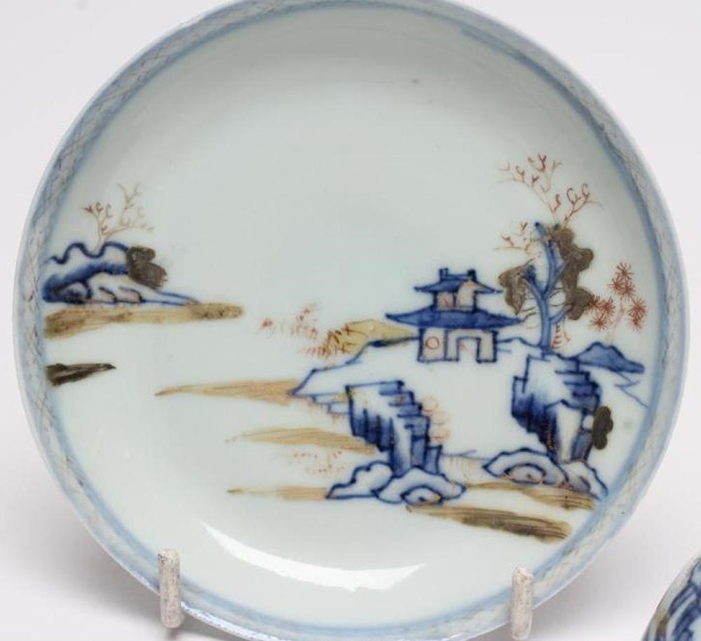 A NANKING CARGO CHINESE PORCELAIN TEA BOWL AND SAUCER painted in underglaze blue and overpainted in Image