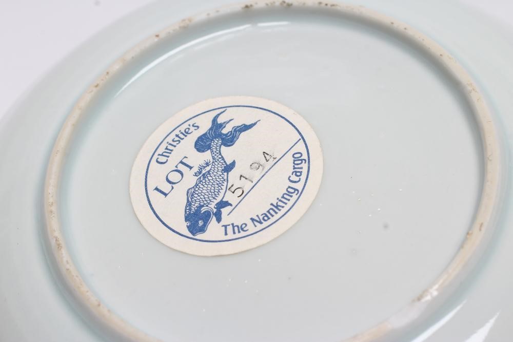 A NANKING CARGO CHINESE PORCELAIN TEA BOWL AND SAUCER painted in underglaze blue and overpainted in Image