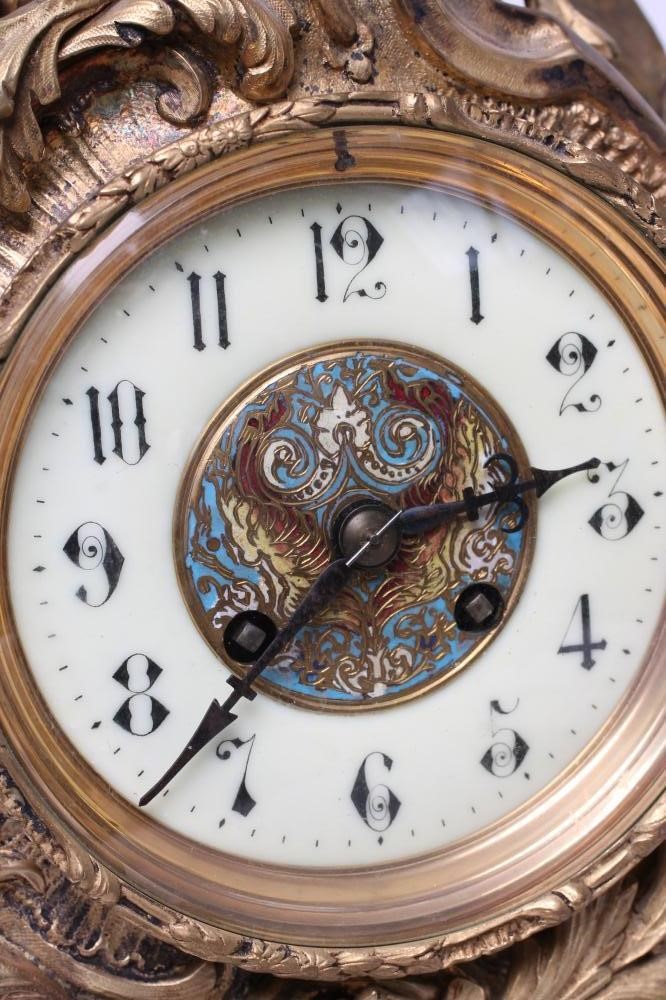 A FRENCH LOUIS XV STYLE ORMOLU AND CHAMPLEVE ENAMEL MANTEL CLOCK Image