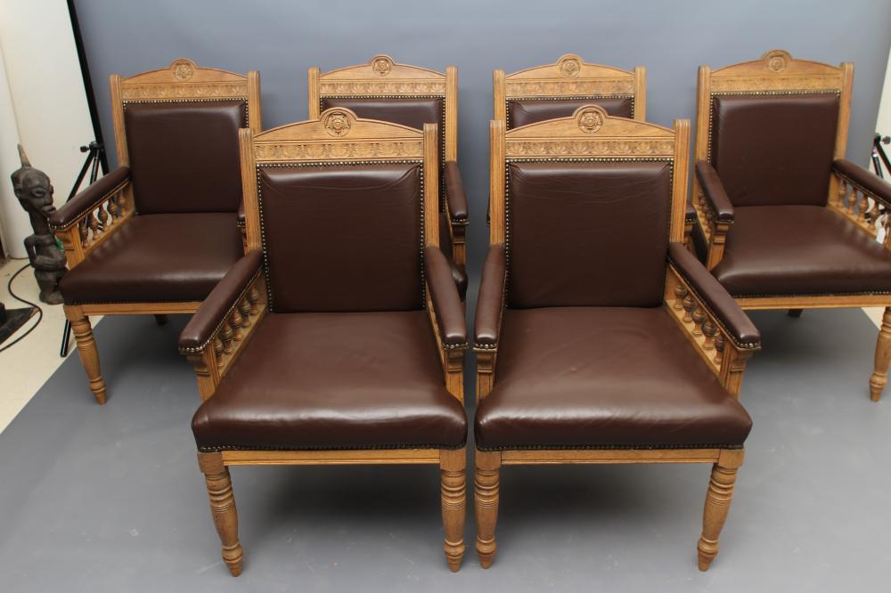 A SET OF SIX VICTORIAN LIMED OAK ELBOW CHAIRS upholstered in brown leather Image