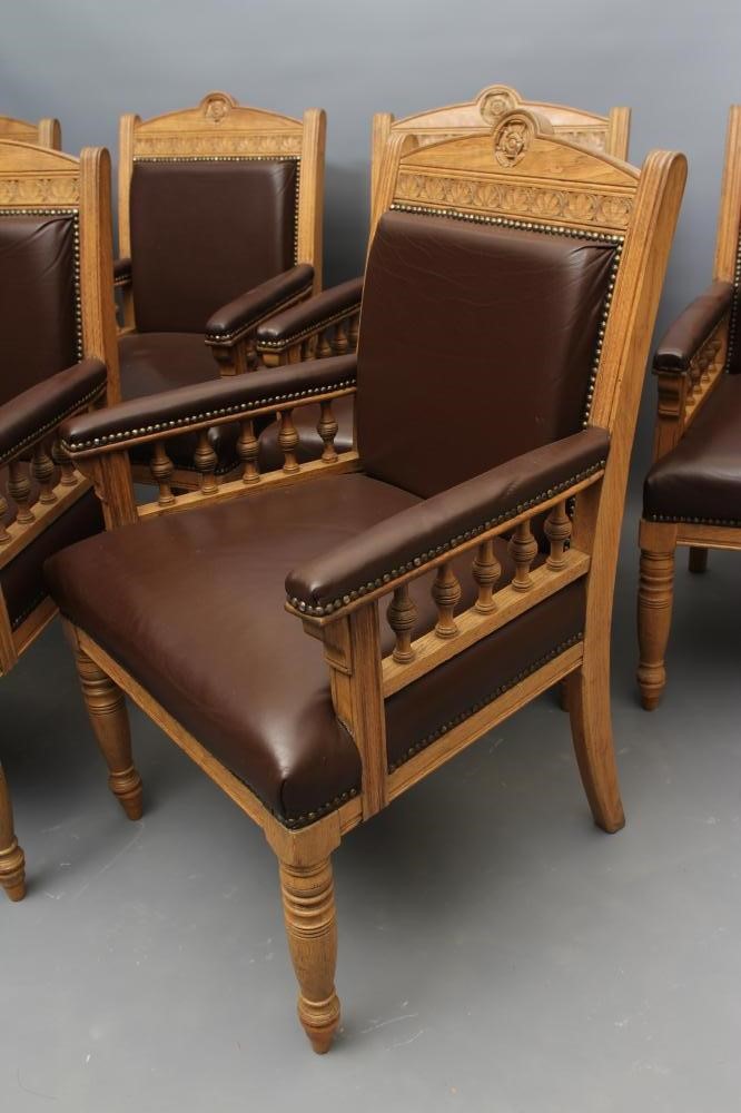 A SET OF SIX VICTORIAN LIMED OAK ELBOW CHAIRS upholstered in brown leather Image