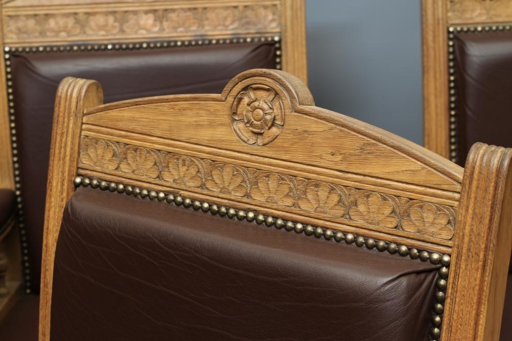 A SET OF SIX VICTORIAN LIMED OAK ELBOW CHAIRS upholstered in brown leather Image