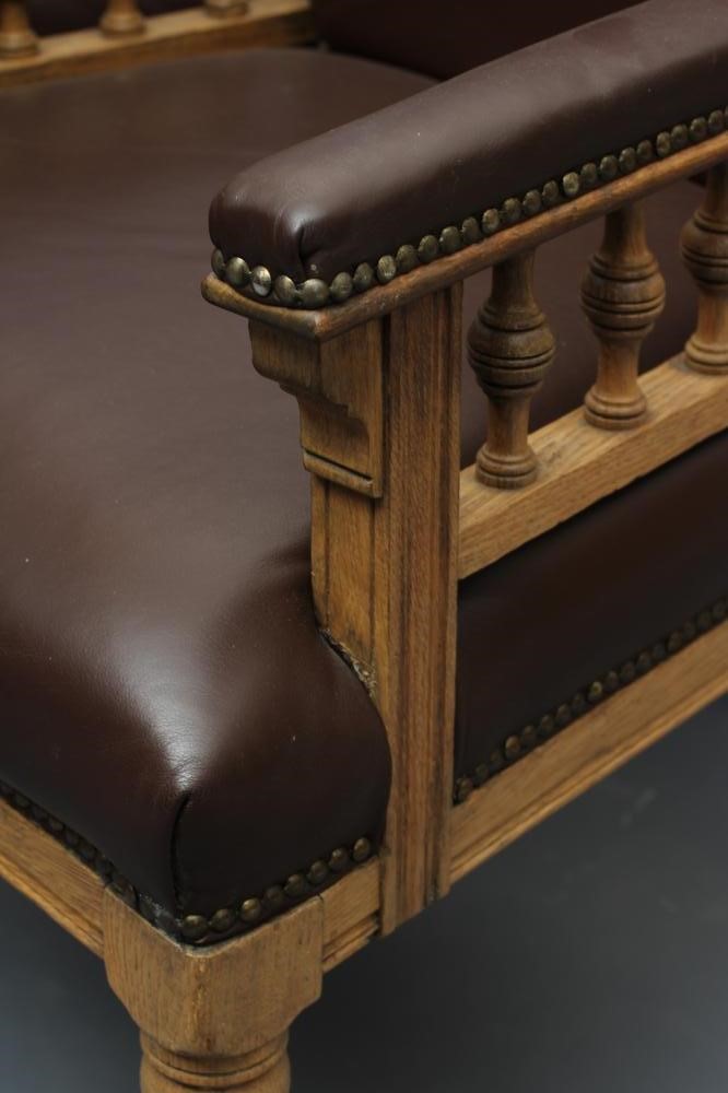 A SET OF SIX VICTORIAN LIMED OAK ELBOW CHAIRS upholstered in brown leather Image