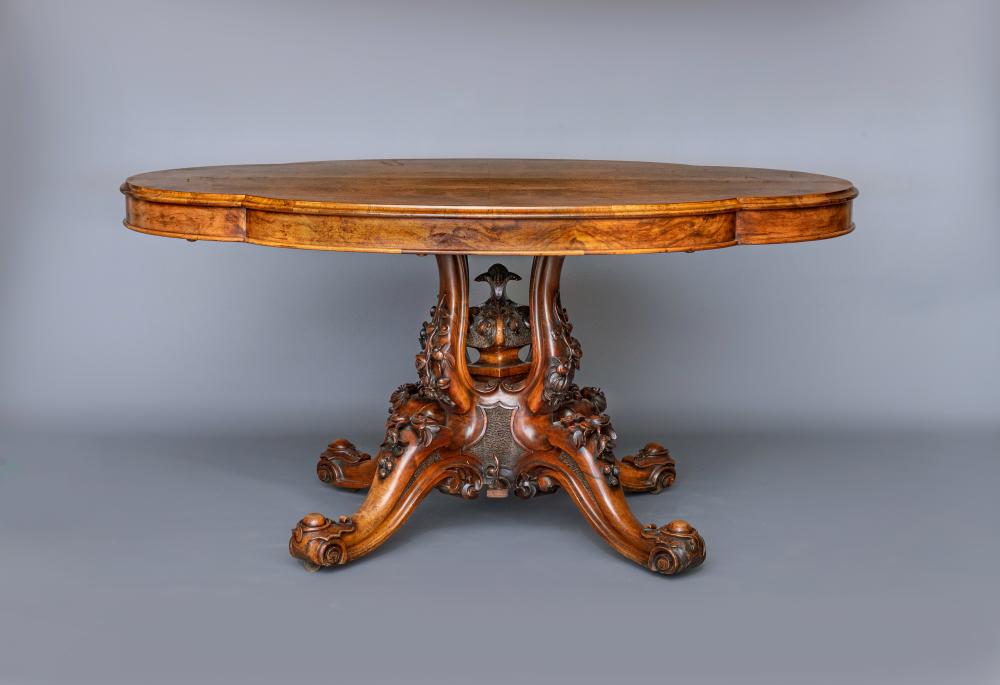 A VICTORIAN WALNUT BREAKFAST TABLE Image