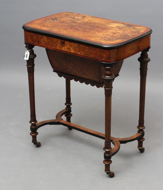 A VICTORIAN WALNUT AND EBONISED SEWING TABLE Image