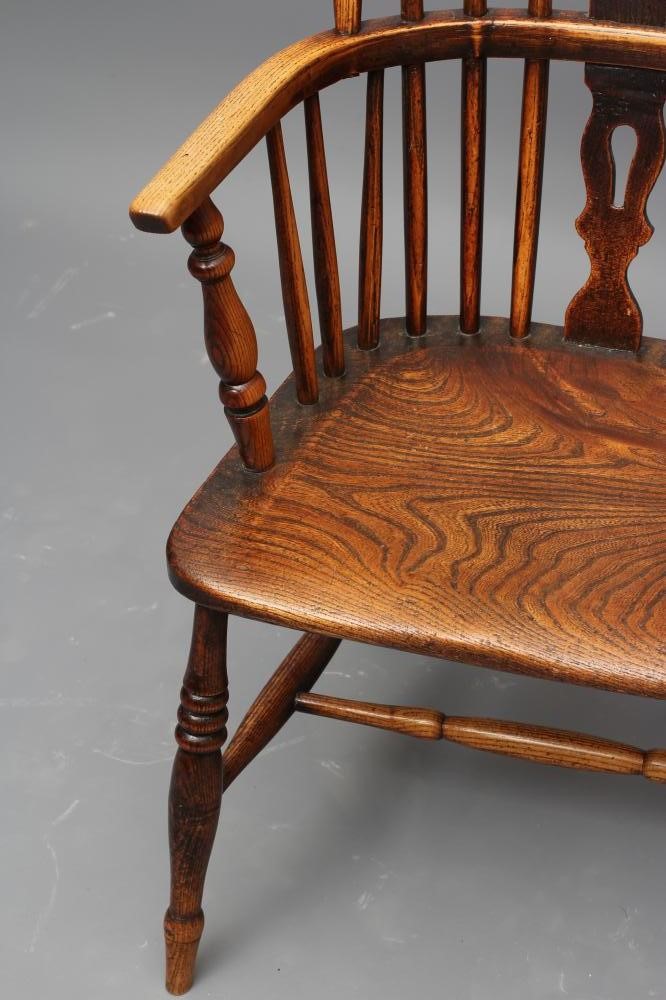 A  WINDSOR SPINDLE BACK ARMCHAIR in ash and elm Image