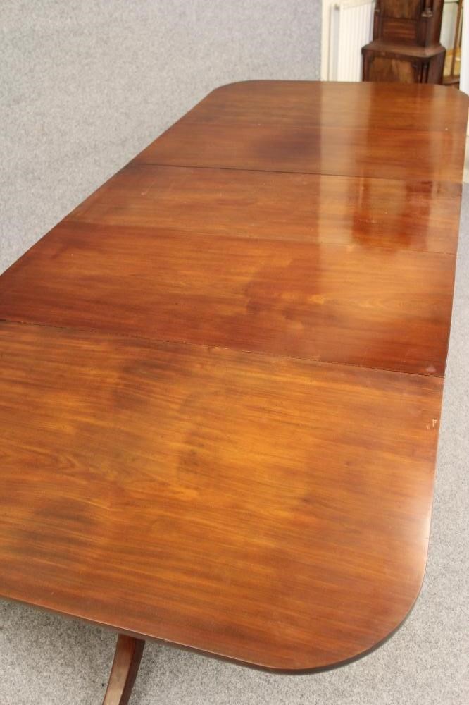 A GEORGIAN MAHOGANY EXTENDING DINING TABLE Image
