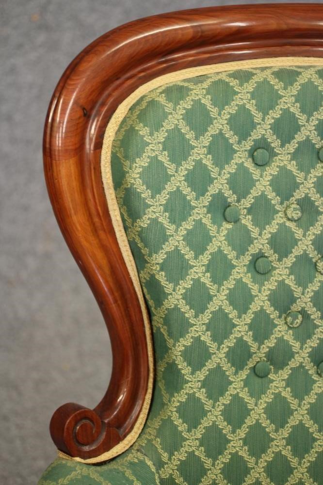 A VICTORIAN WALNUT FRAMED ARMCHAIR of spoon back form button upholstered in a cream and green weave Image