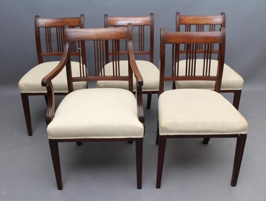 A SET OF FIVE GEORGIAN MAHOGANY DINING CHAIRS including an elbow chair Image
