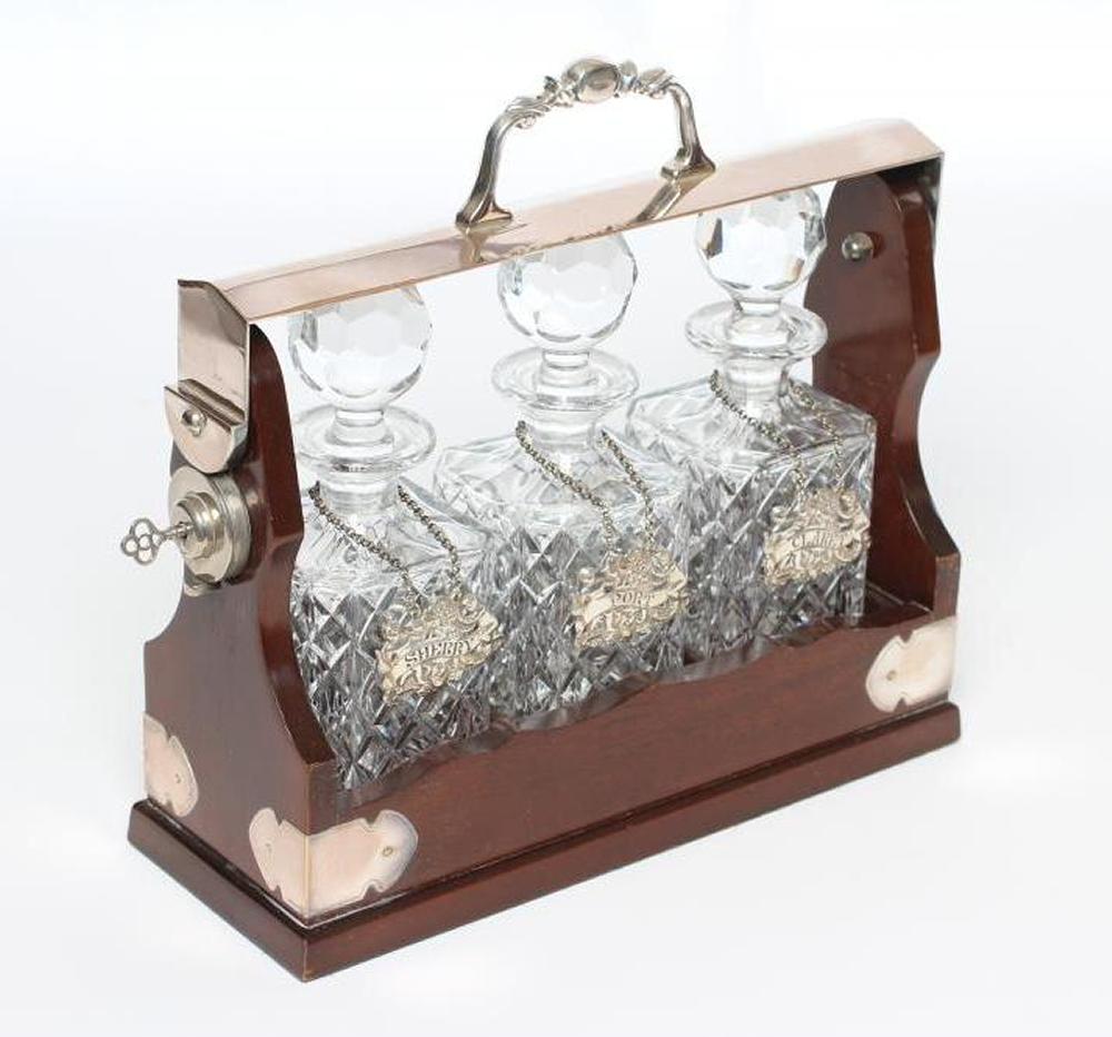 A SET OF THREE SILVER BOTTLE TICKETS Image