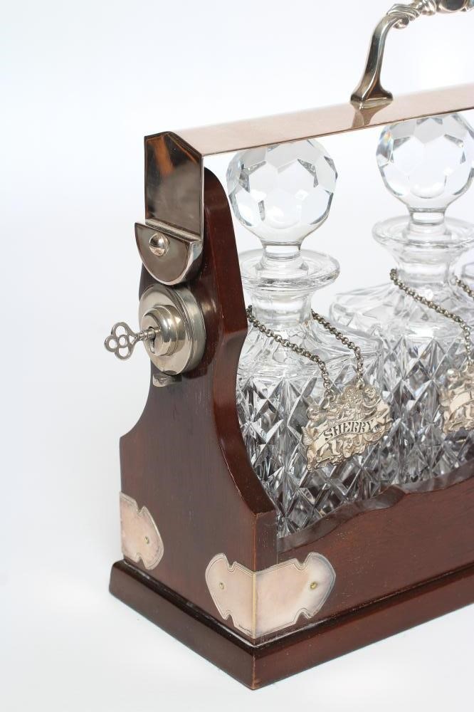 A SET OF THREE SILVER BOTTLE TICKETS Image