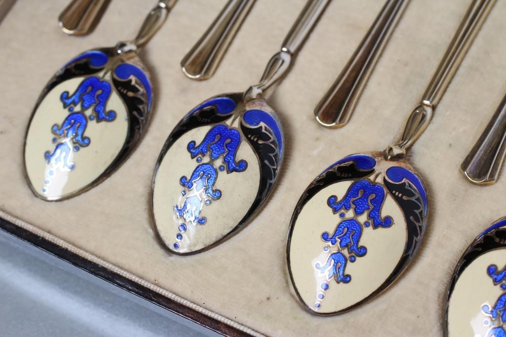 A MATCHED SET OF TWELVE SILVER GILT AND ENAMEL COFFEE SPOONS Image