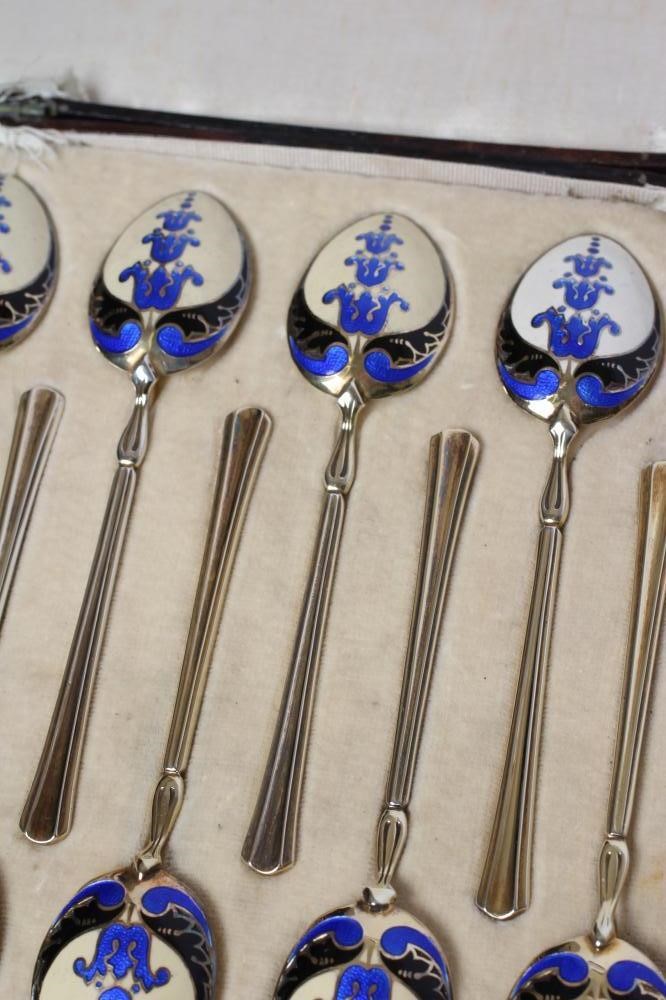 A MATCHED SET OF TWELVE SILVER GILT AND ENAMEL COFFEE SPOONS Image
