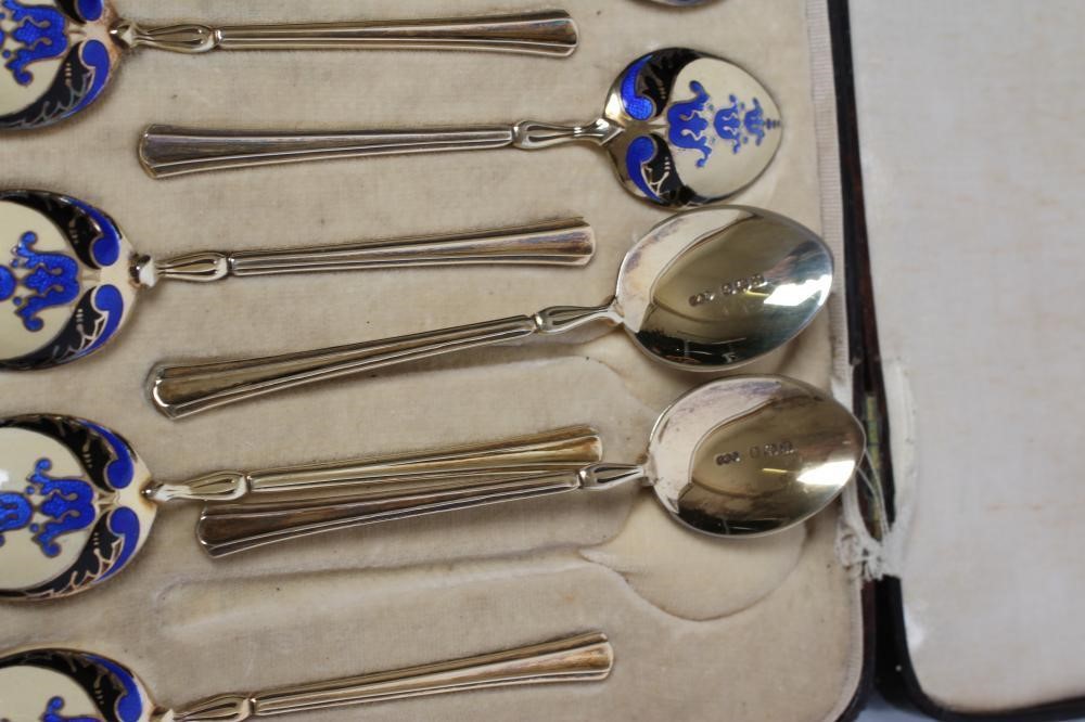 A MATCHED SET OF TWELVE SILVER GILT AND ENAMEL COFFEE SPOONS Image