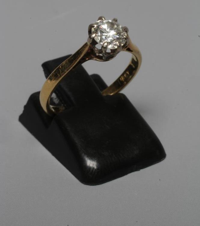 A SOLITAIRE DIAMOND RING, the old brilliant cut stone of approximately 0.60cts claw set to a plain Image