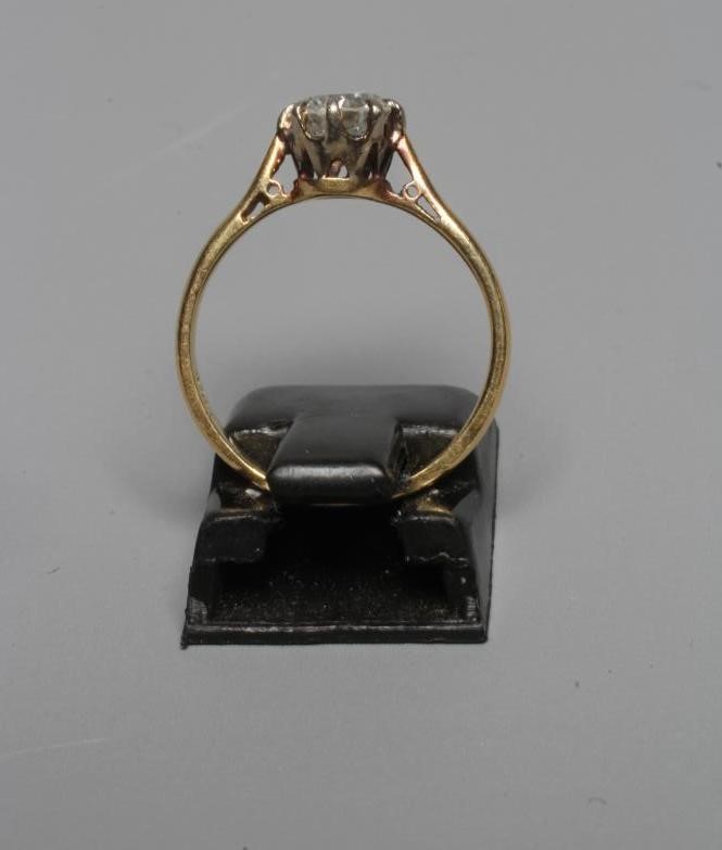 A SOLITAIRE DIAMOND RING, the old brilliant cut stone of approximately 0.60cts claw set to a plain Image