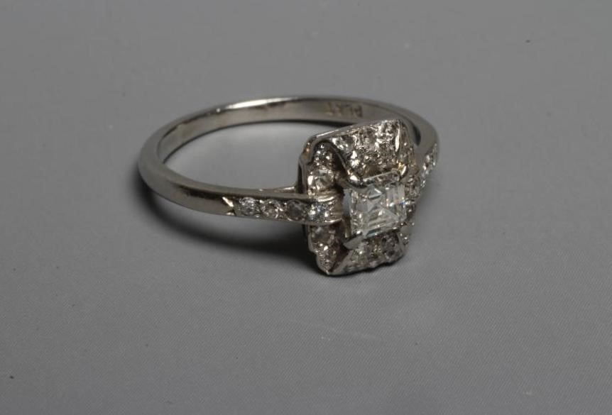 AN ART DECO DIAMOND COCKTAIL RING, the central Princess cut stone claw set to a domed border set Image