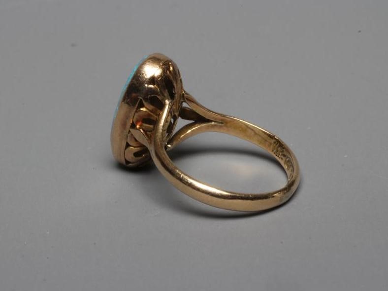 AN OPAL DRESS RING, the oval cabochon polished stone collet set to a plain shank stamped 14k, WK, Image