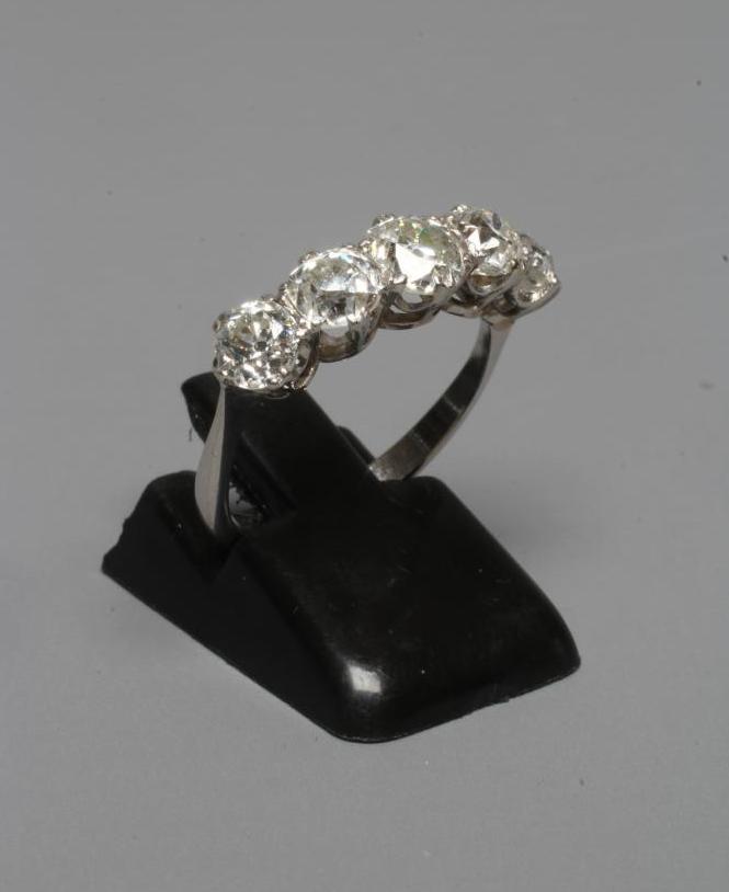 A FIVE STONE DIAMOND RING, the central stone of approximately 0.5cts, all claw set to a plain white Image