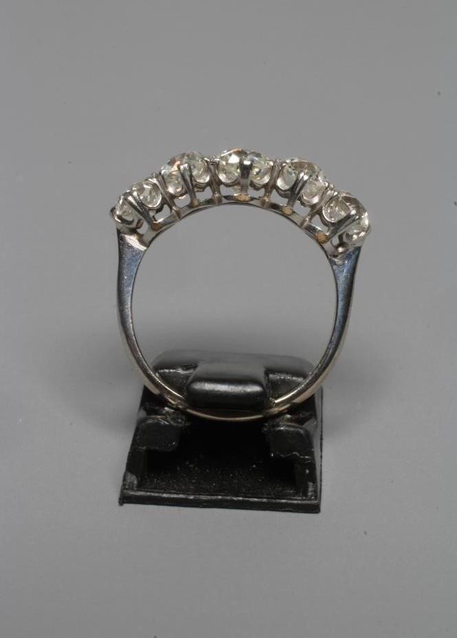 A FIVE STONE DIAMOND RING, the central stone of approximately 0.5cts, all claw set to a plain white Image