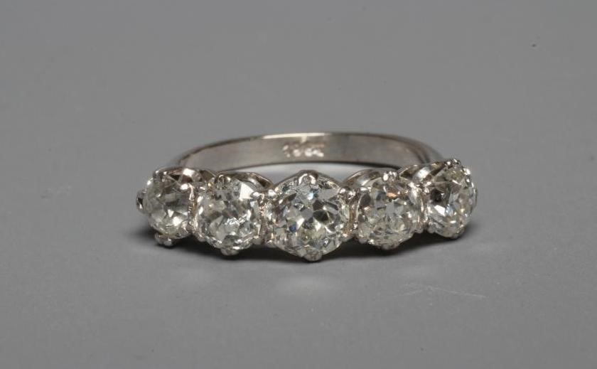 A FIVE STONE DIAMOND RING, the central stone of approximately 0.5cts, all claw set to a plain white Image
