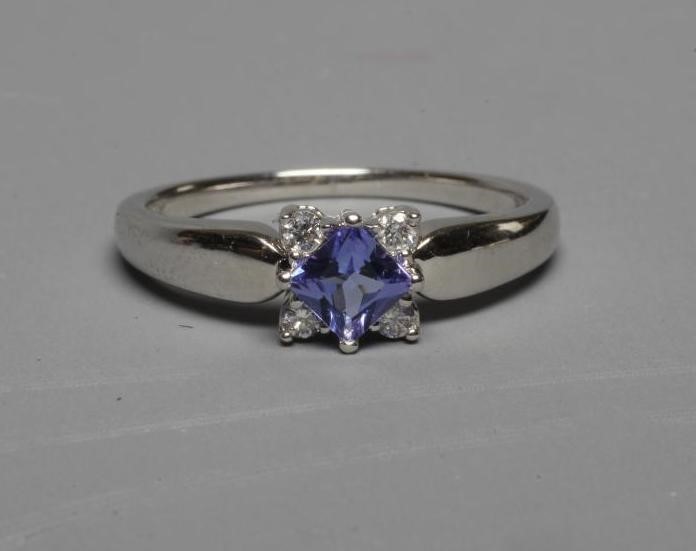 A TANZANITE AND DIAMOND RING, the square facet cut tanzanite claw set with four small diamonds to Image