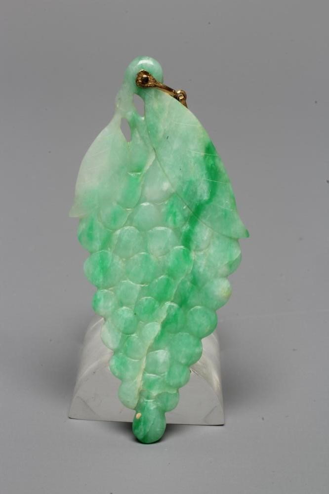 A CHINESE JADE PENDANT carved in low relief as a bunch of grapes, with unmarked metal bale (Est. Image