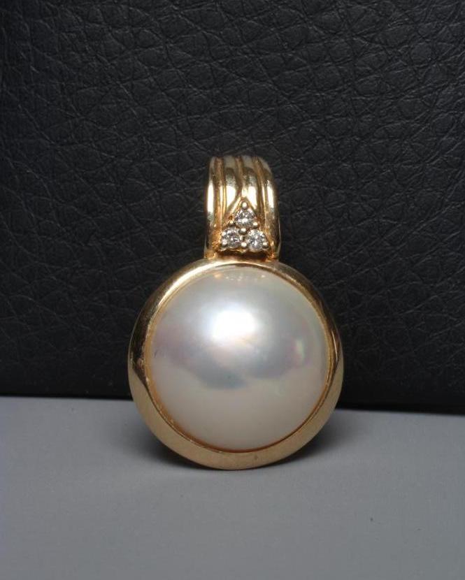 A MABE PEARL PENDANT collet set to a plain frame below a reeded bale set with three small diamonds, Image