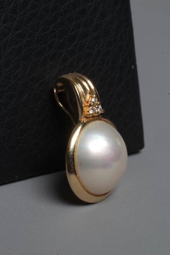 A MABE PEARL PENDANT collet set to a plain frame below a reeded bale set with three small diamonds, Image