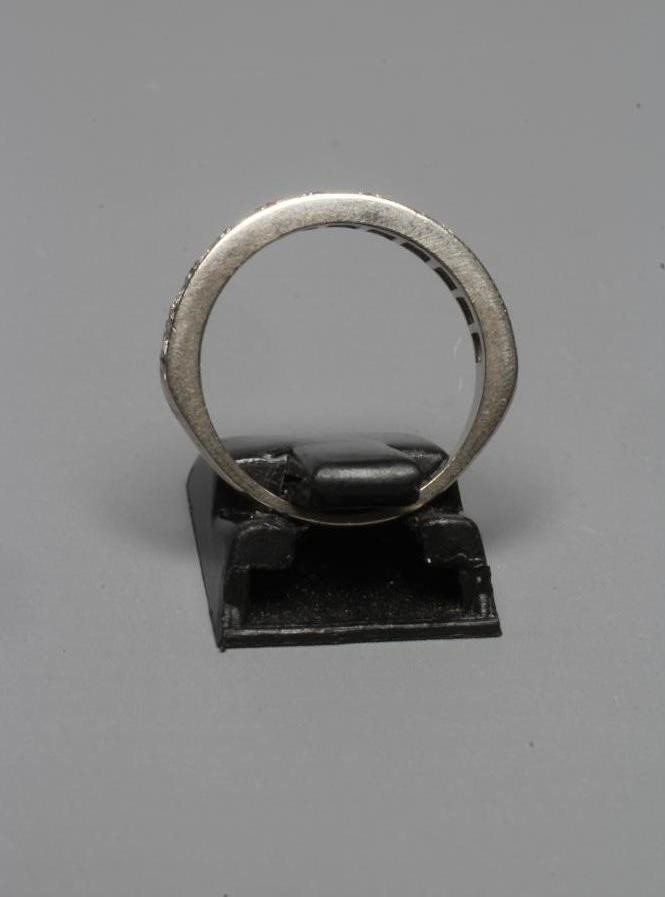 A DIAMOND HALF HOOP ETERNITY RING, the eleven small brilliants pave set to a white shank stamped Image