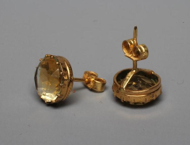 A PAIR OF LATE VICTORIAN CITRINE EAR STUDS, the circular facet cut stones collet set in plain mounts Image