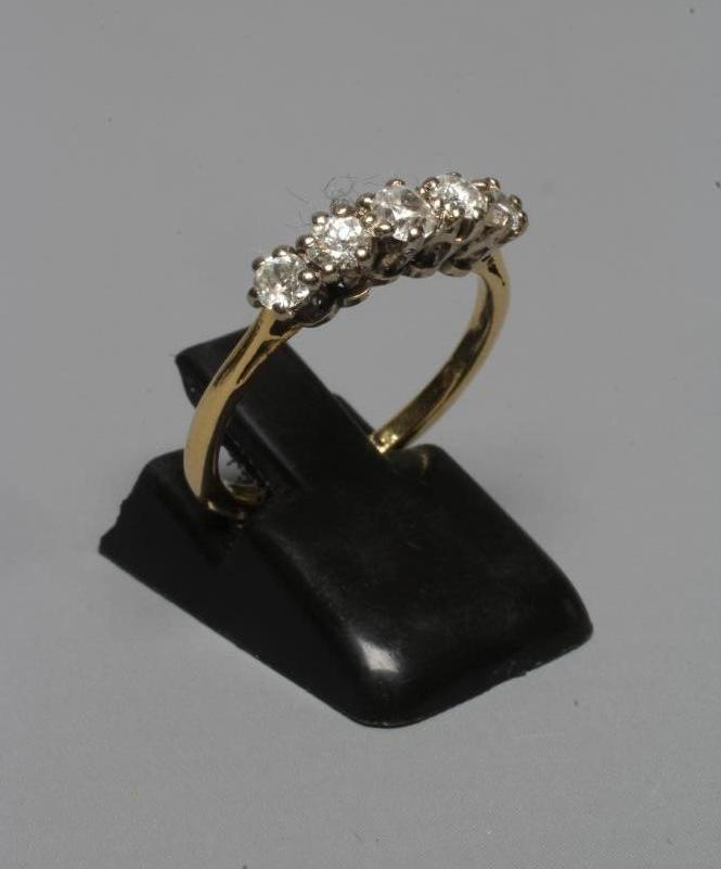 A FIVE STONE DIAMOND RING, the old brilliant cut stones claw set to a plain shank stamped 18ct, size Image