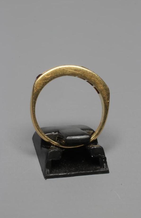 A MULTI-GEM HALF HOOP RING, the seven square cut stones including garnet, aquamarine and amethyst Image