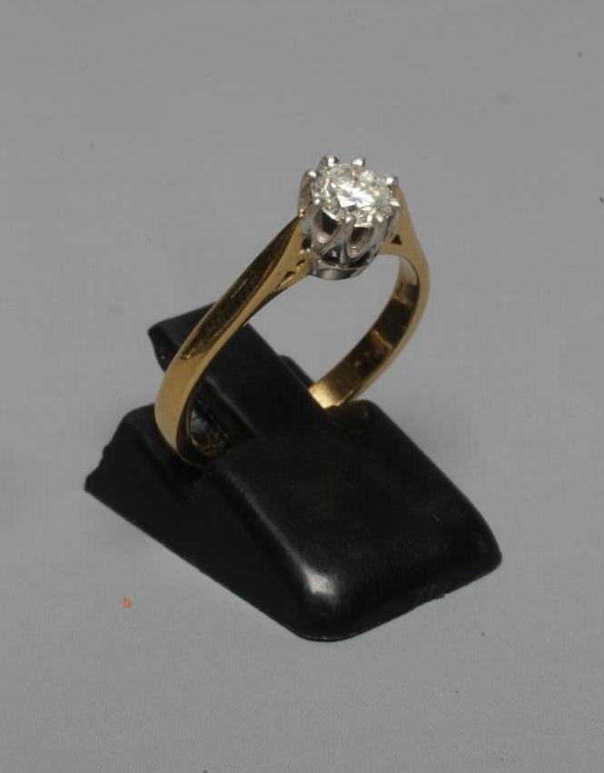 A SOLITAIRE DIAMOND RING, the brilliant cut stone of approximately 0.5cts claw set to a plain 18ct Image