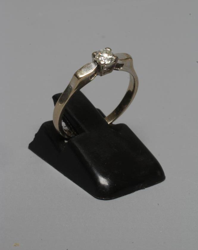 A SOLITAIRE DIAMOND RING, the brilliant cut stone of approximately 0.12cts claw set to angular Image
