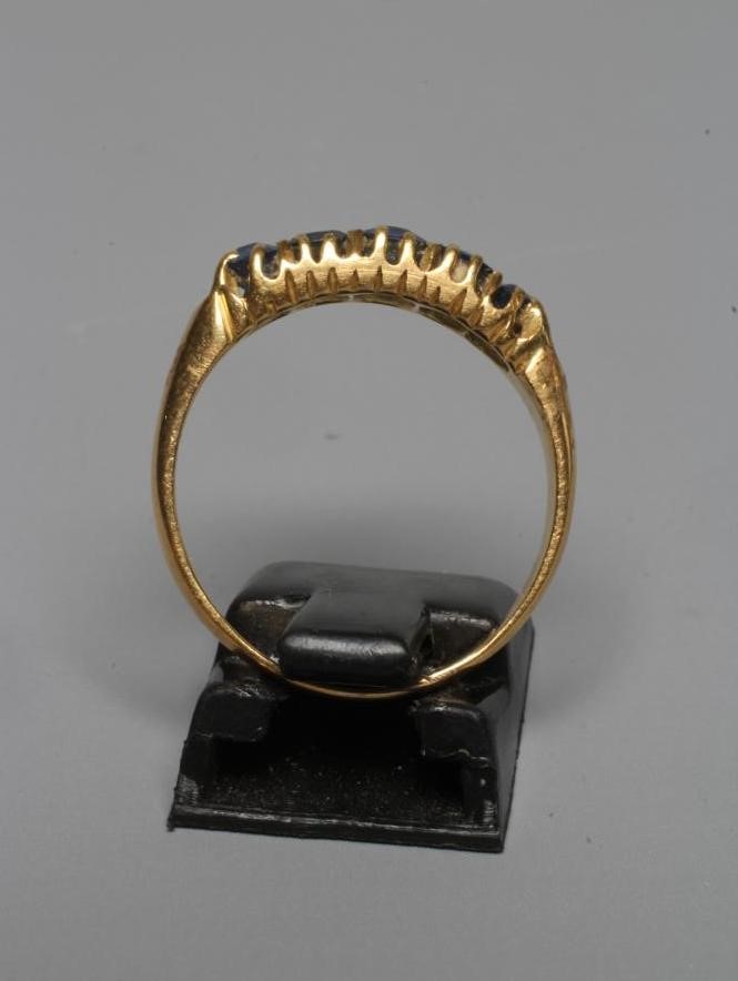 A MID VICTORIAN FIVE STONE SAPPHIRE RING, the graduated facet cut stones claw set to a plain 18ct Image