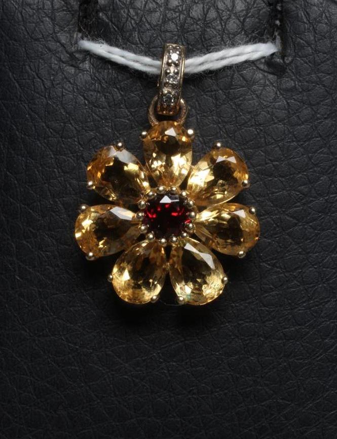 A MULTI-GEM FLOWERHEAD CLUSTER PENDANT centred by a circular facet cut garnet with seven citrine Image