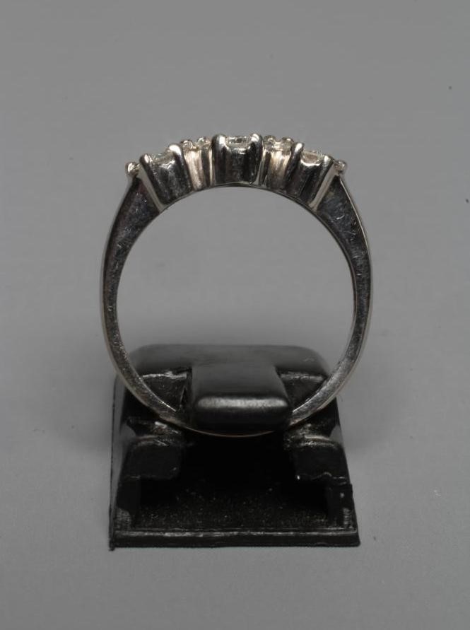 A DIAMOND TRIPLE CLUSTER RING, the brilliant cut stones claw set to plain shoulders and a white Image