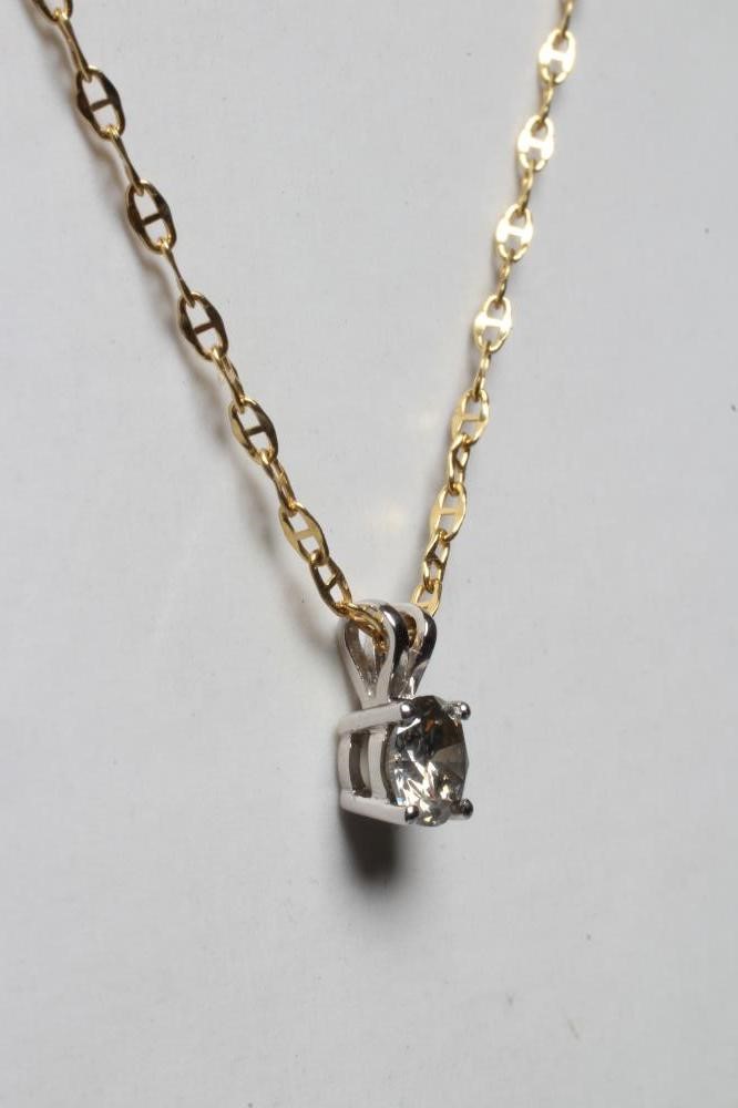 A SOLITAIRE DIAMOND PENDANT, the claw set brilliant cut stone to an 18ct gold bi-furcated bale, Image