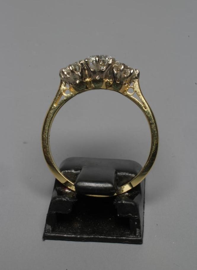 A THREE STONE DIAMOND RING, the brilliant cut stones totalling 1.25cts, claw set to a plain shank Image