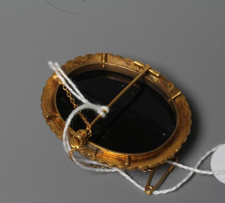 A JASPER CAMEO carved with the head and shoulders of a young girl wearing a wreath in her hair on a Image