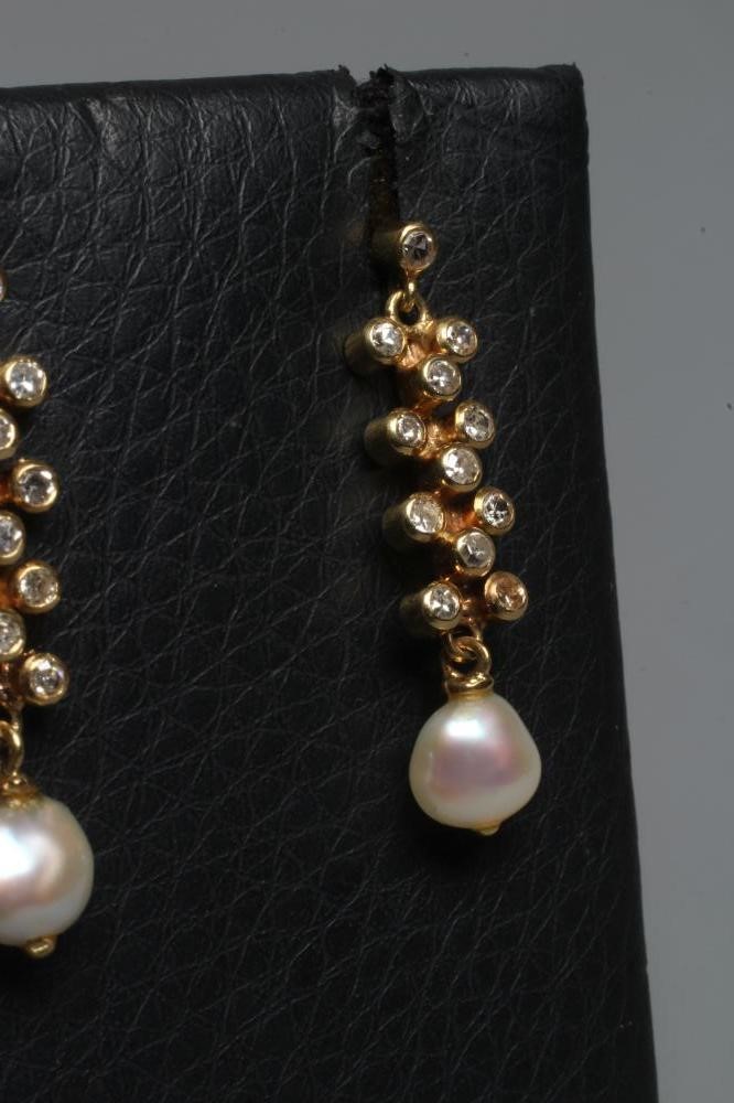 A PAIR OF DIAMOND AND FRESHWATER PEARL DROP EARRINGS, the pearls hung from a bar set with eleven Image