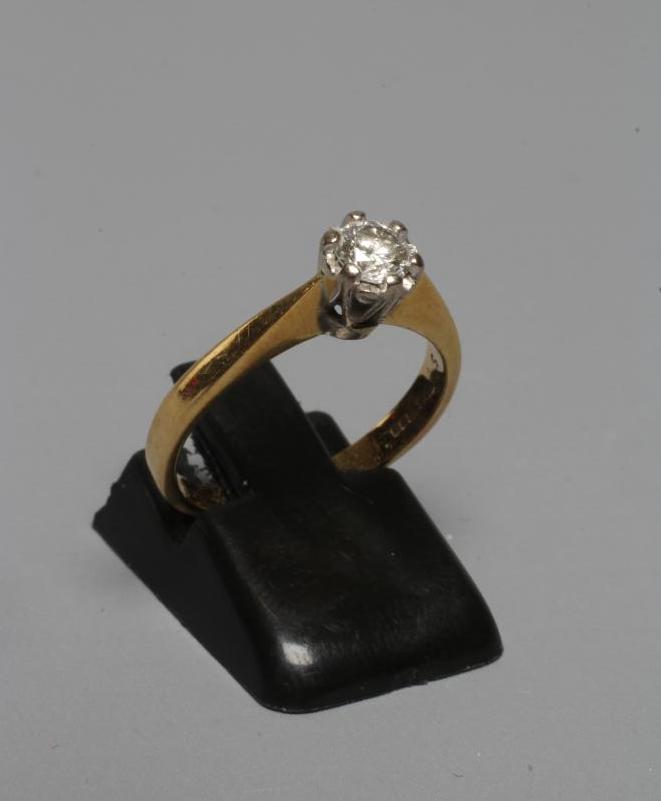 A SOLITAIRE DIAMOND RING, the brilliant cut stone of approximately 0.5cts, claw set to a plain 18ct Image