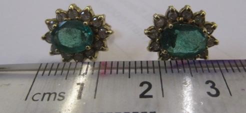 A PAIR OF EMERALD AND DIAMOND CLUSTER EAR STUDS Image