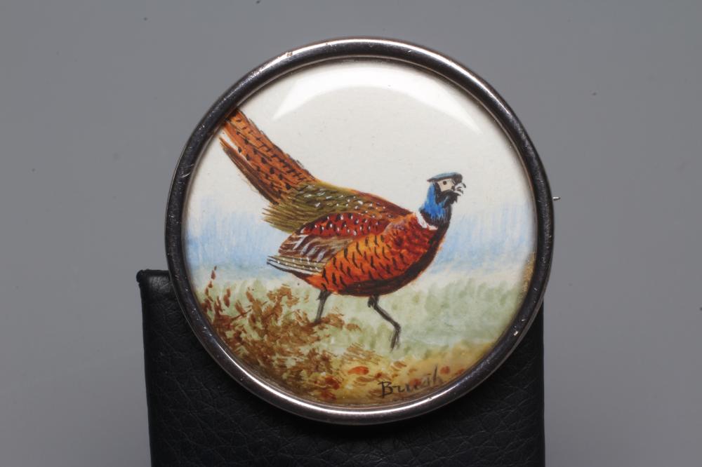 AN EDWARDIAN CIRCULAR SILVER BROOCH/CLIP, inset with a watercolour painting of a pheasant in Image