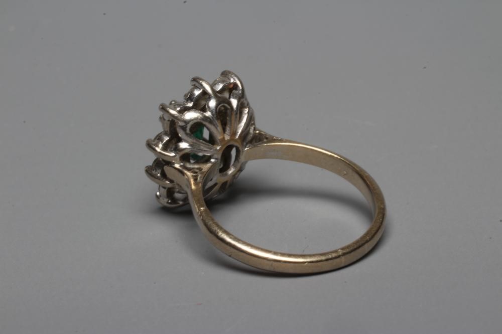 AN EMERALD AND DIAMOND CLUSTER RING Image