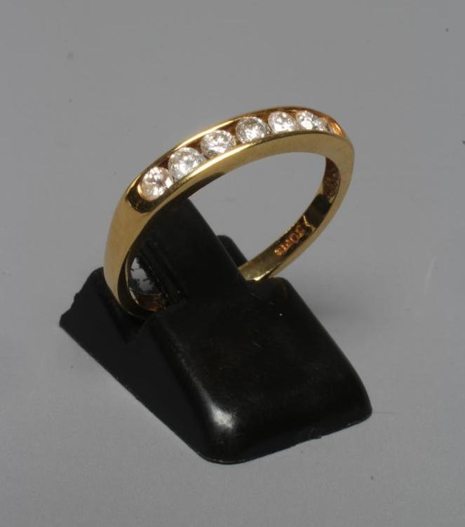 A SEVEN STONE DIAMOND HALF HOOP ETERNITY RING, the brilliant cut stones totalling 0.5cts, channel Image