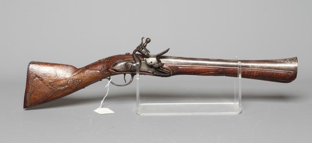 A FLINTLOCK BLUNDERBUSS PISTOL with 12" white metal inlaid barrel, carved and inlaid wood stock and Image